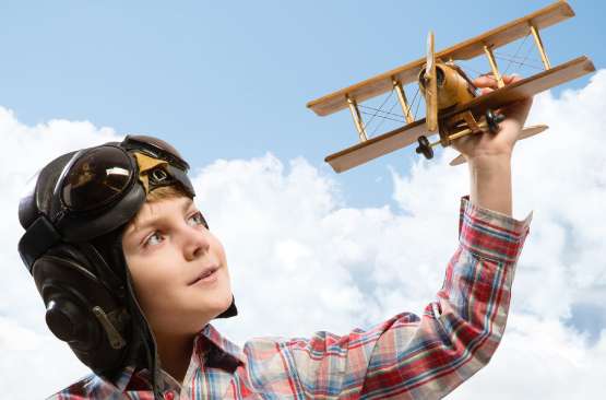 kid with aircraft toy photo